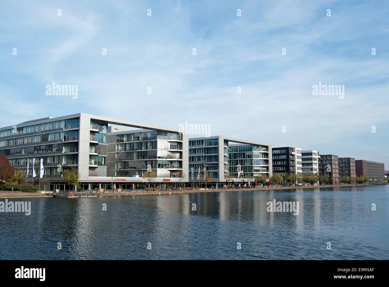 view towards office blocks and ground level restaurants across the inner harbour, or innenhafen, duisburg, germany, Stock Photo