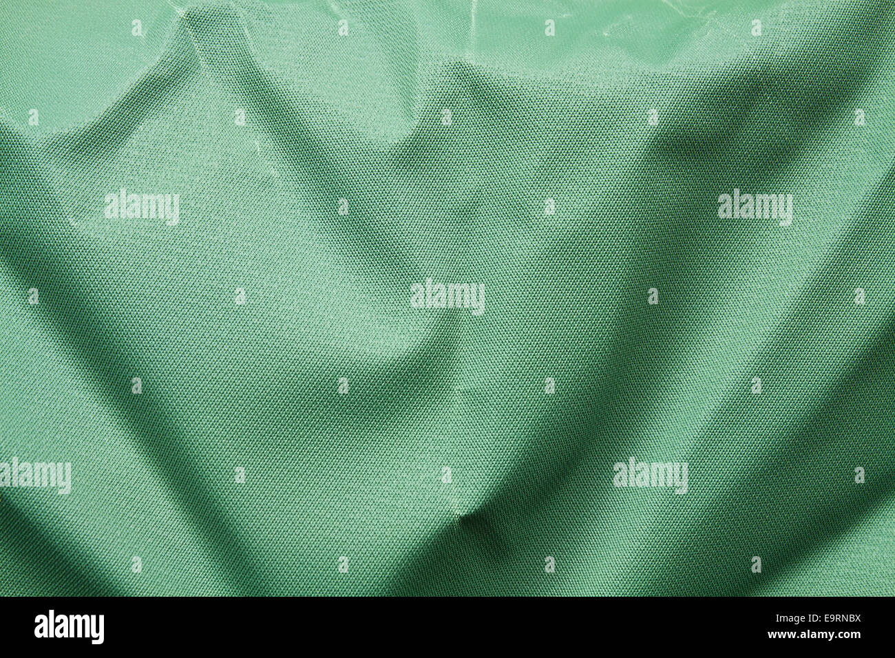 Wrinkled green plastic imitation canvas background Stock Photo