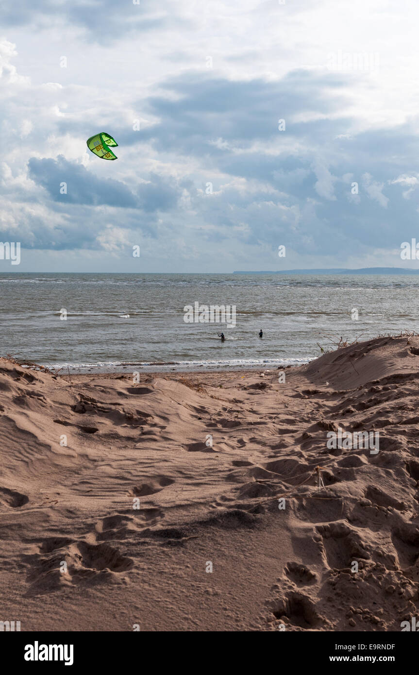 Male and female kite surfers on a windy day at Exmouth in Devon, UK. Good conditions for kite