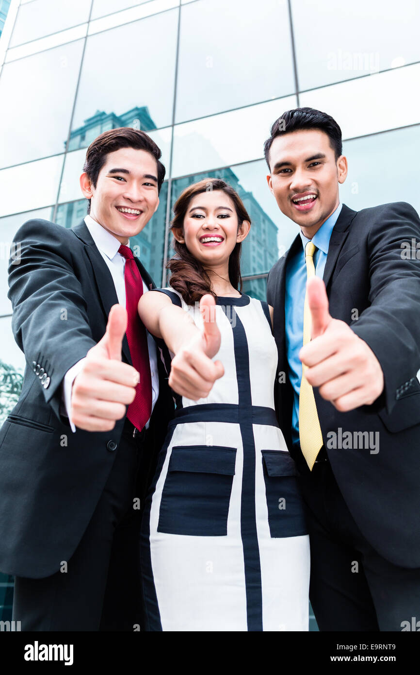 Asian business woman and men outside in front of building Stock Photo ...