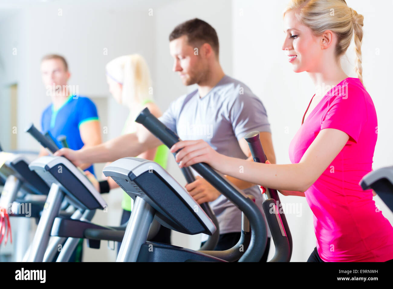 Group of fitness people in sport gym on treadmill Stock Photo - Alamy
