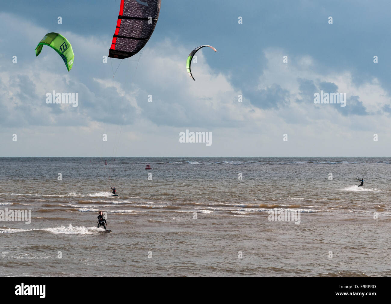Kite surfers on a windy day at Exmouth in Devon, UK. Good conditions for kite surfing. Stock Photo