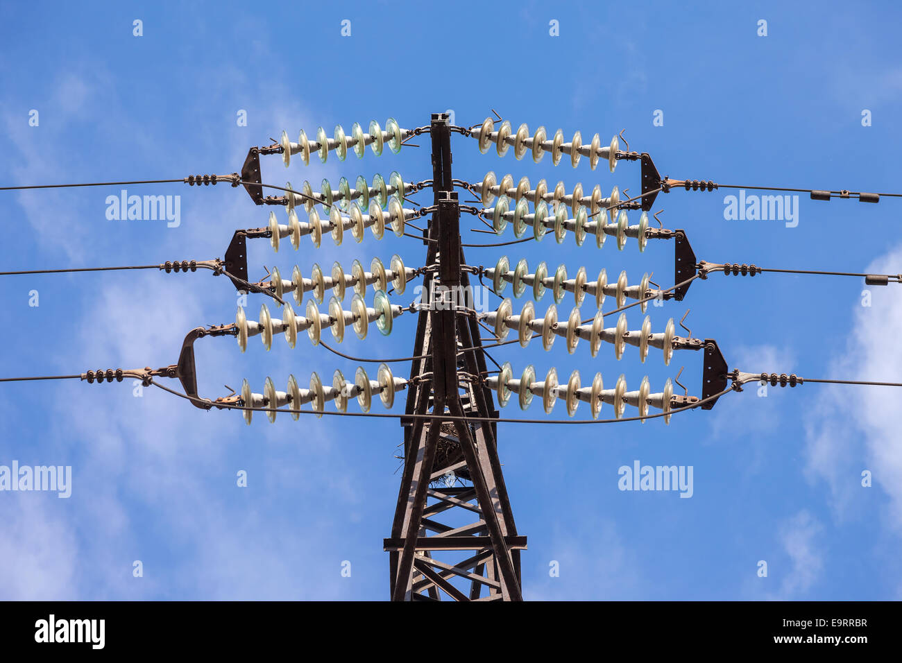 High voltage electric tower against blue sky Stock Photo - Alamy