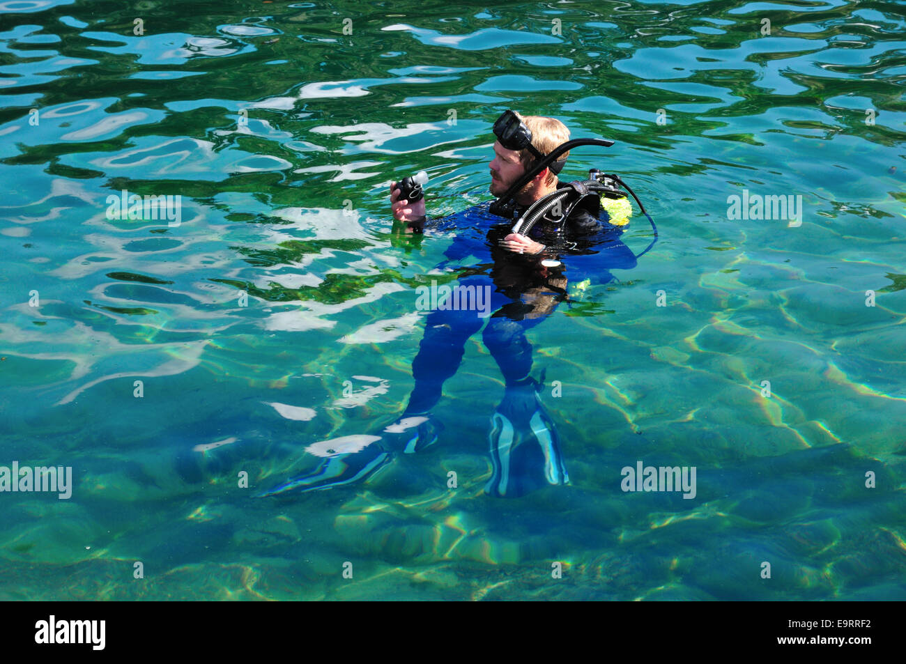 SCUBA diver checking his equipment in the pool at De Leon Springs state park, Florida Stock Photo