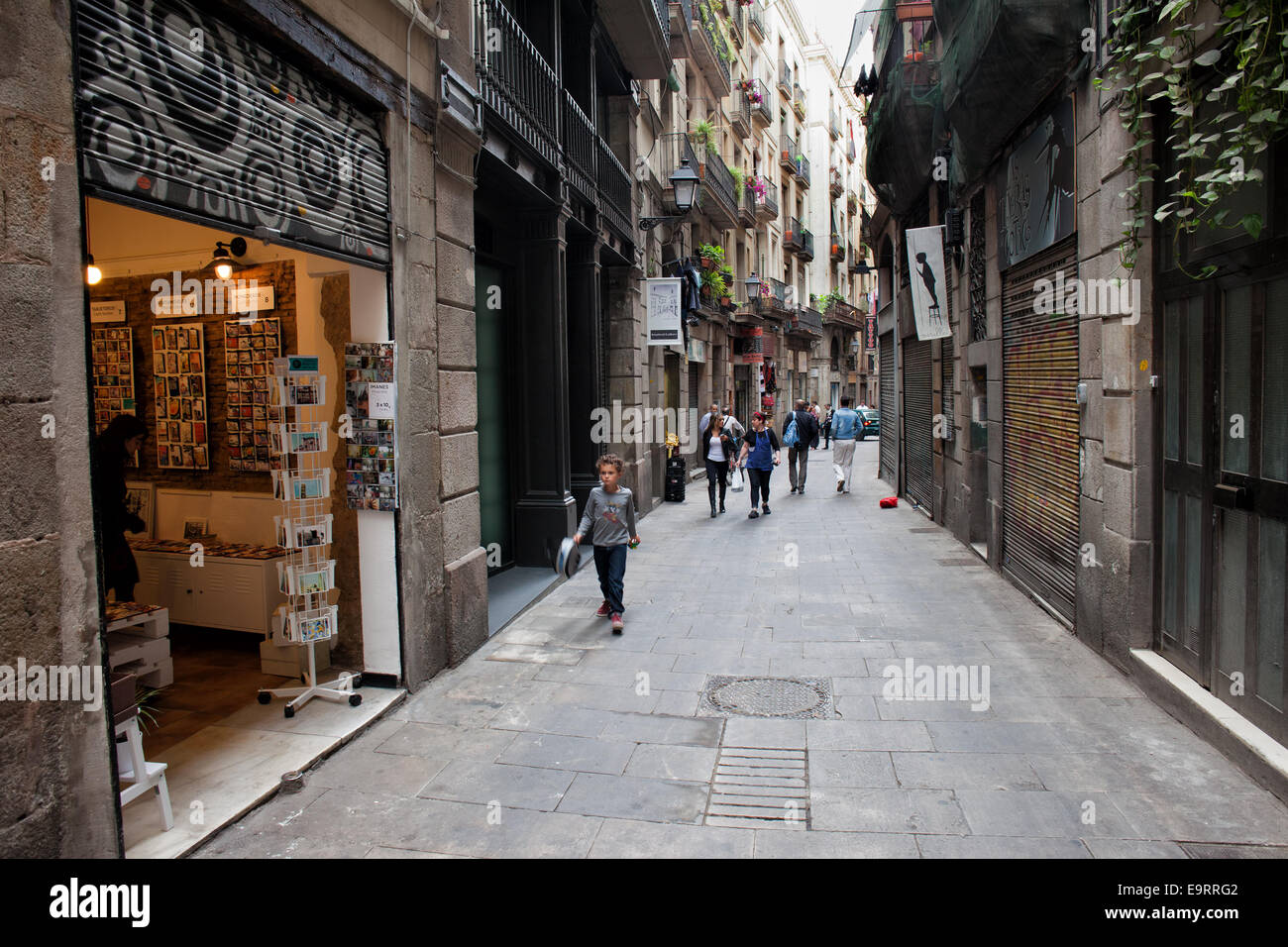 Open souvenir shop on narrow street in Gothic Quarter of Barcelona in