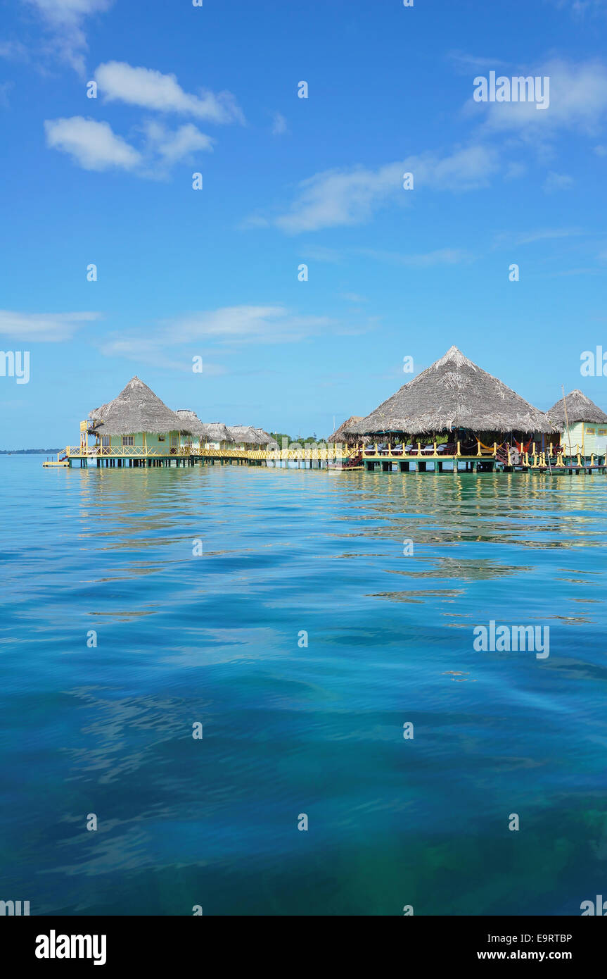 Tropical resort over the sea with thatched roof cabins and restaurant, Caribbean, Central America, Panama Stock Photo