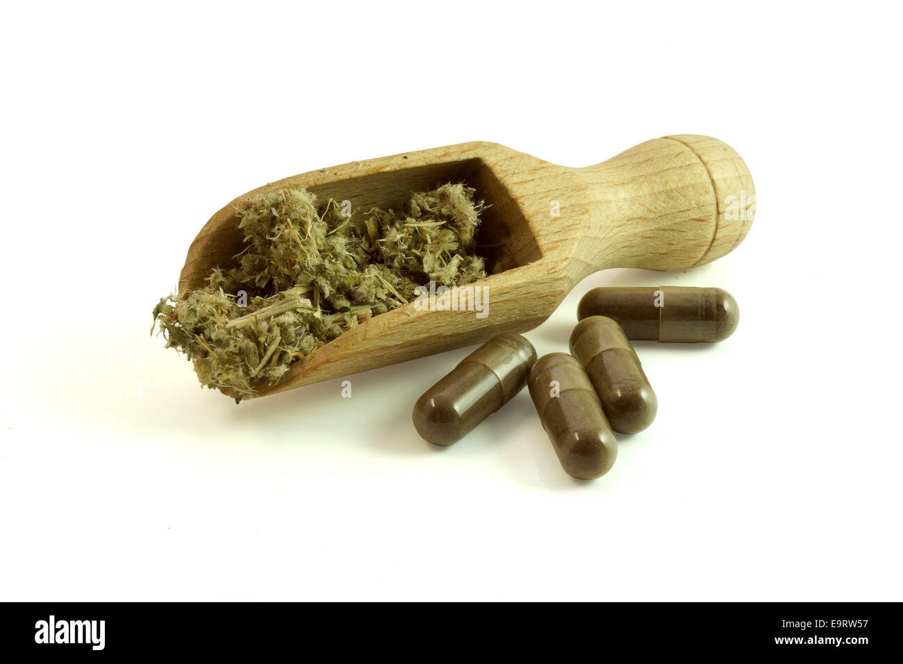 Homeopathy. Healing herbs with scoop and herbal pills Stock Photo