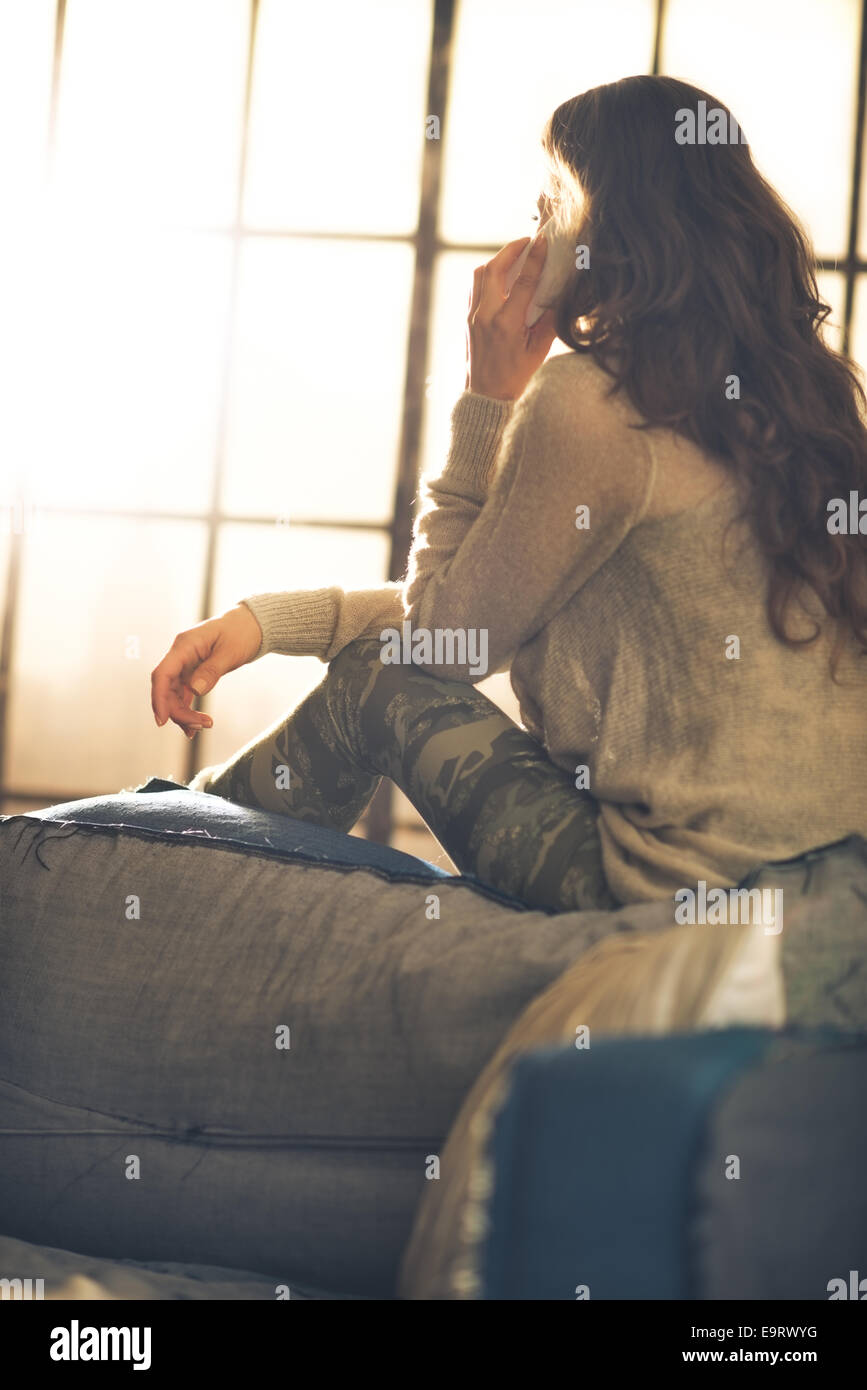 Woman speaking mobile phone rear view hi-res stock photography and ...