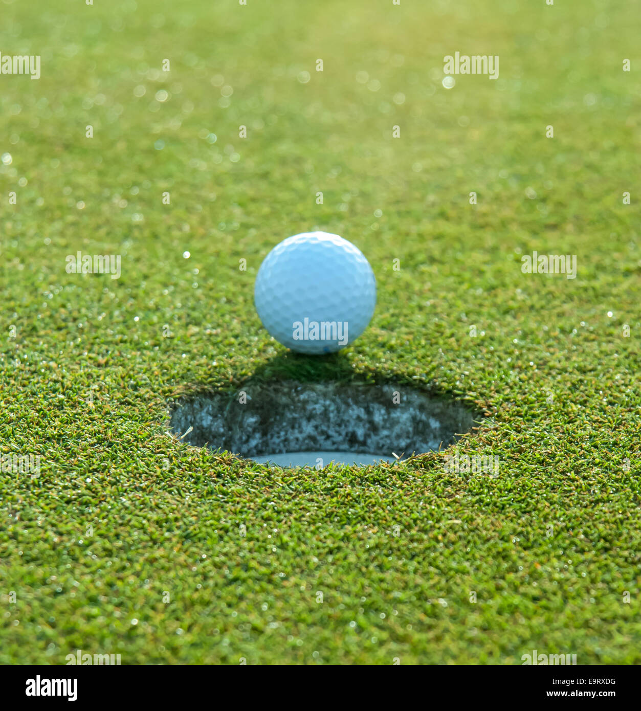 Golf ball approaches hole Stock Photo Alamy