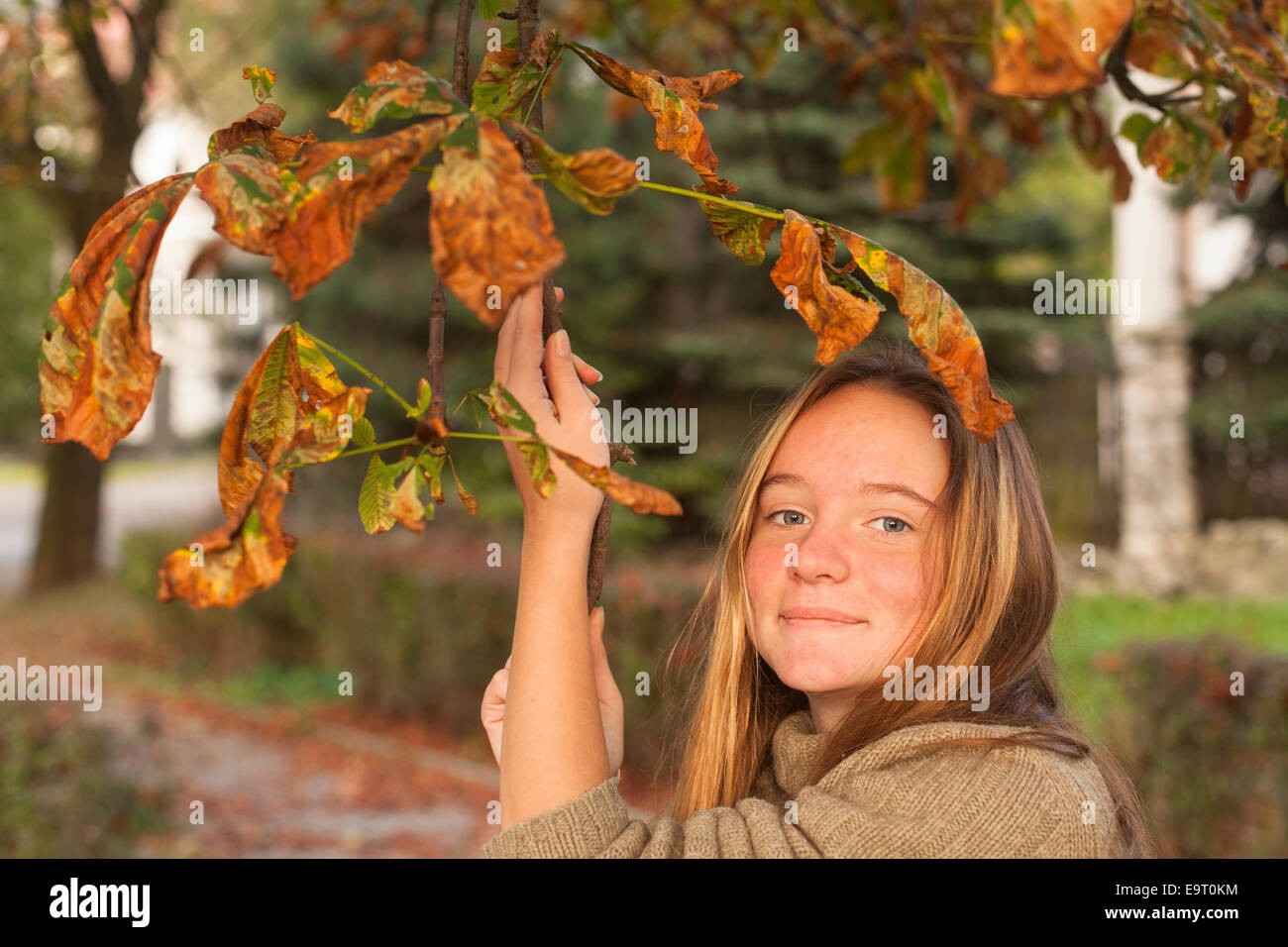 Portrait of young cute girl in autumn park Stock Photo - Alamy