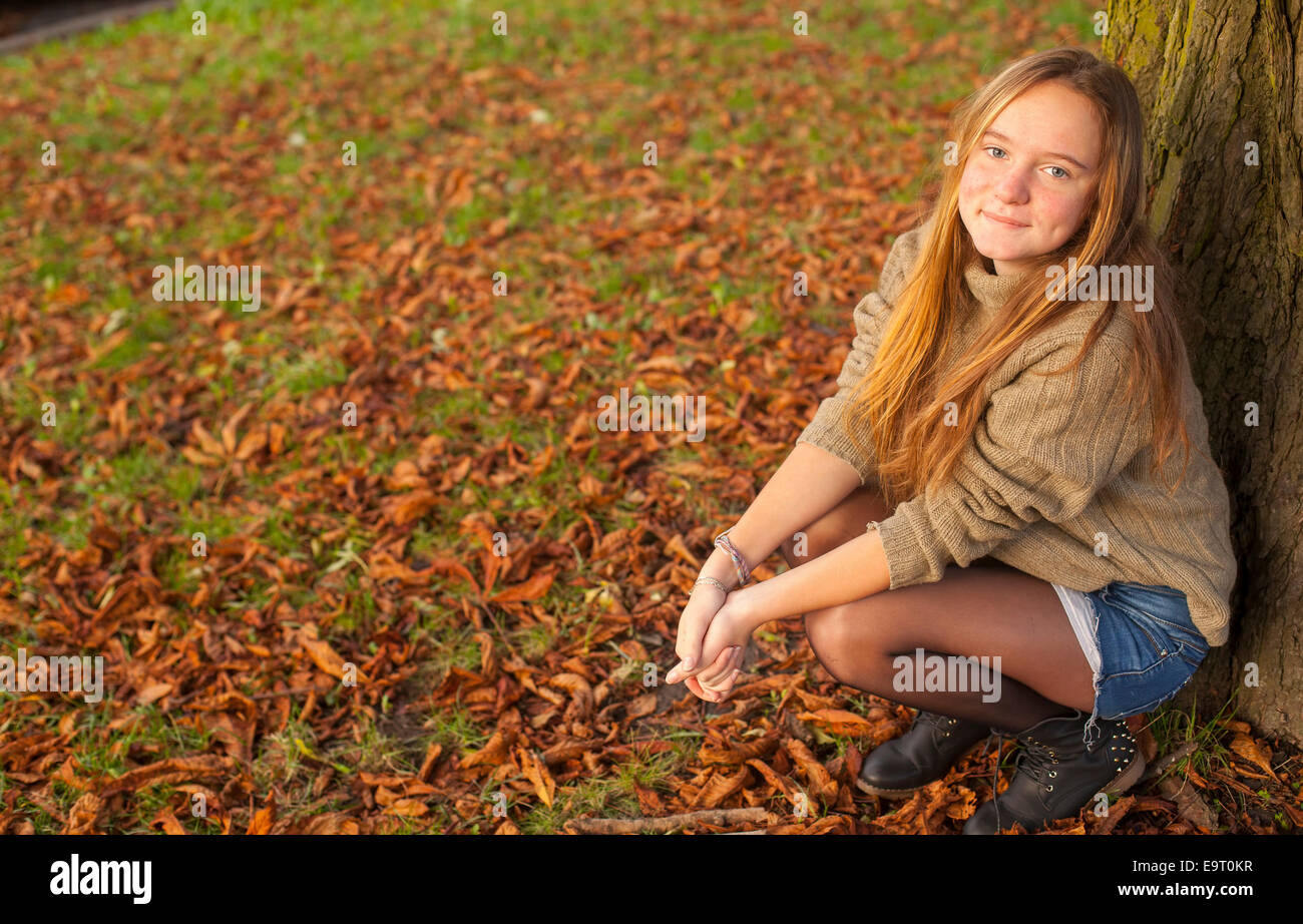 Young pretty girl in autumn park Stock Photo - Alamy