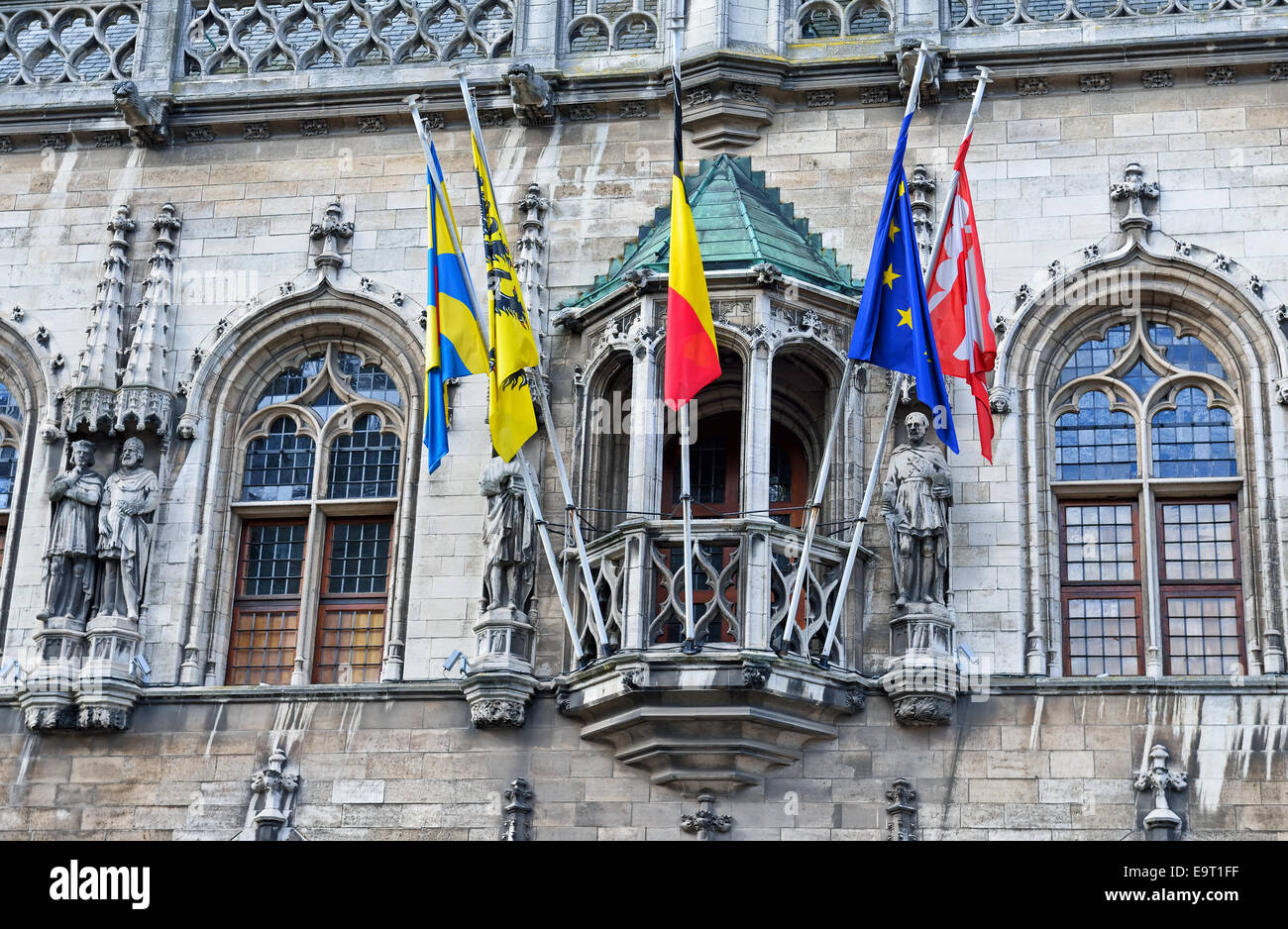 Medieval City Hall of Courtrai or Kortrijk, Belgium with flags of country and regions Stock Photo