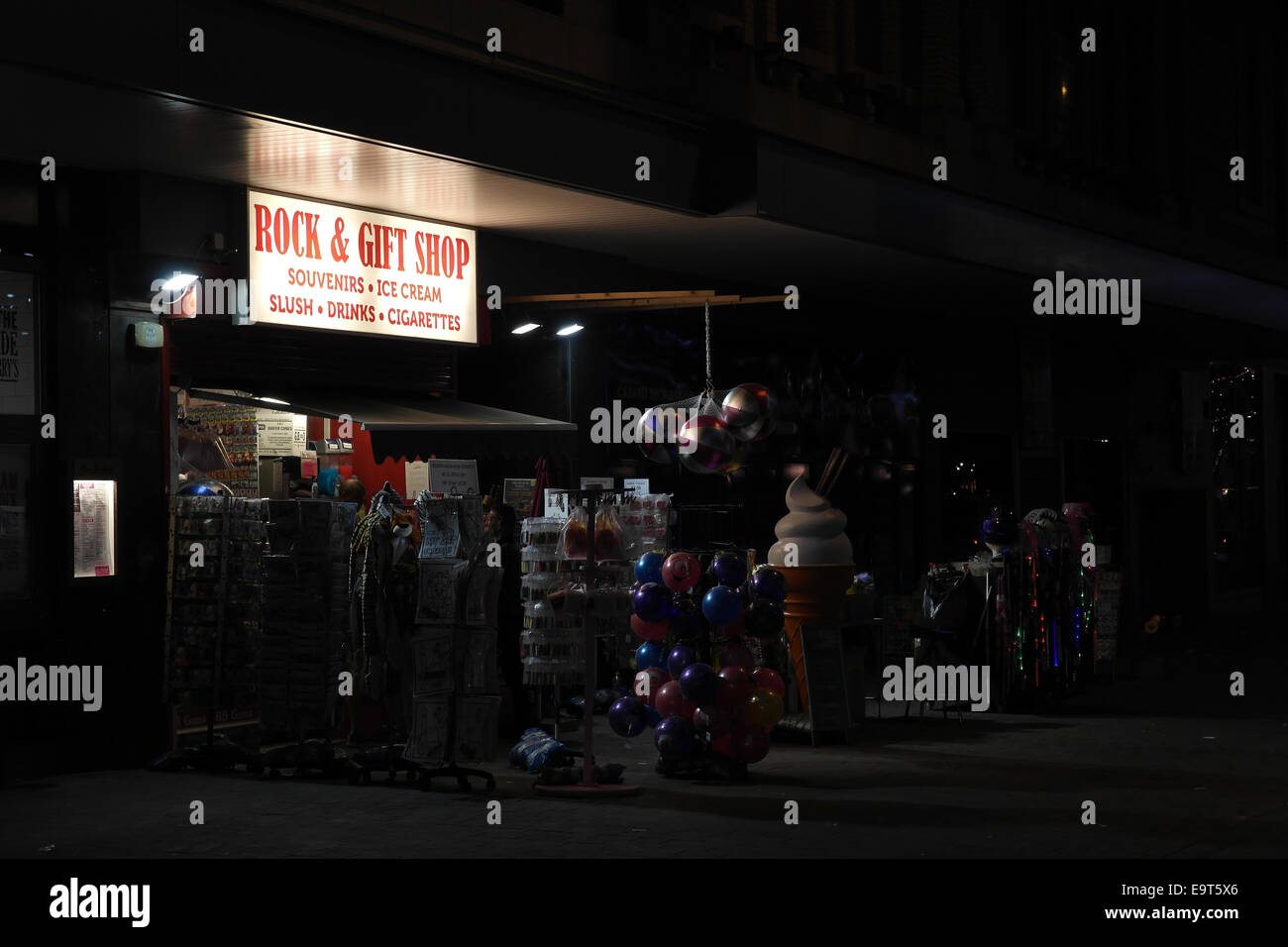 Night oblique view pavement novelties neon 'Rock Gift Shop', near Harry