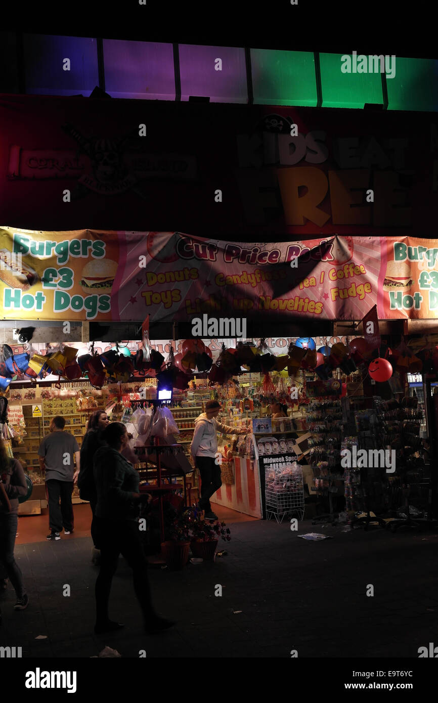 Night portrait electric lights open front shop selling novelties