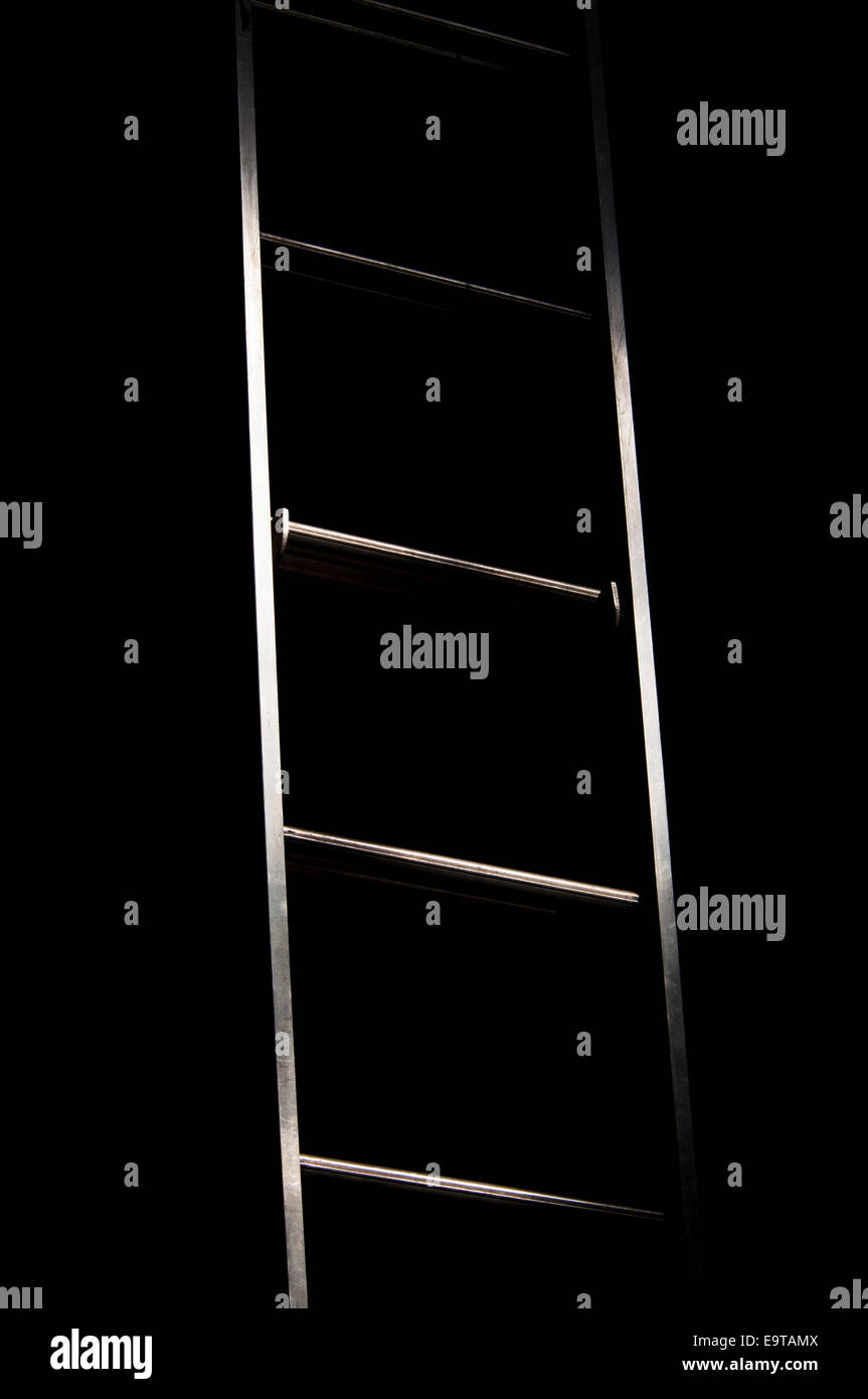 An abstract, high contrast image of ladder leading from light to dark Stock Photo