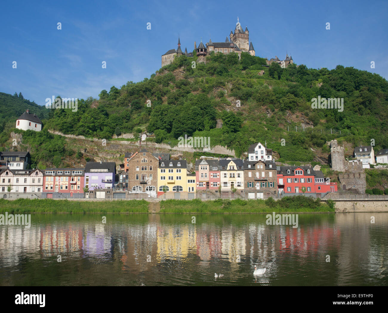 Colourful river front buildings and Reichsburg Castle Moselle River Germany Stock Photo