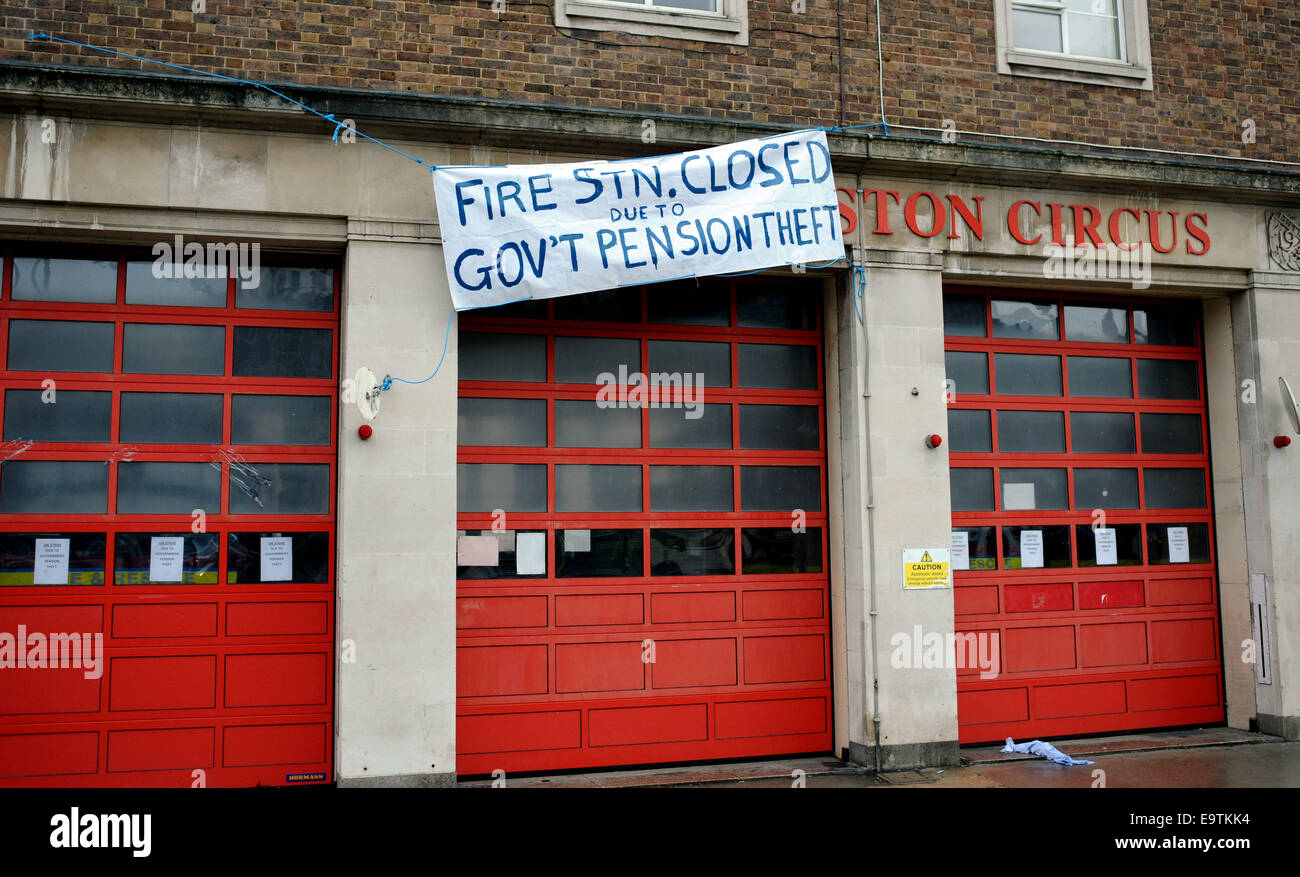 2nd Nov, 2014. A banner hanging from the Preston Circus Fire Station in Brighton saying 'Closed Due to Government Pension Theft' Stock Photo