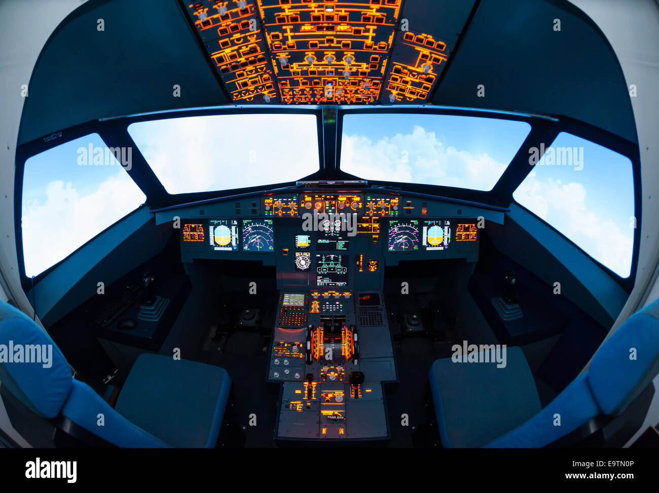 Cockpit of an Airbus A320 flight simulator that is used for training of professional airline pilots (fisheye lens distortion) Stock Photo