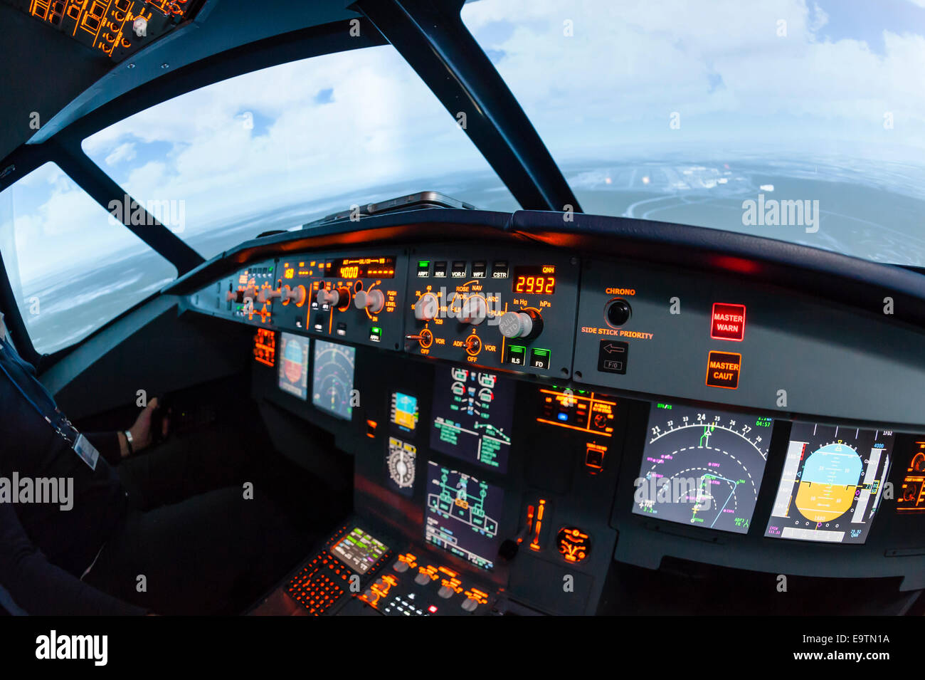 Cockpit of an Airbus A320 flight simulator that is used for training of professional airline pilots (flashing warning light) Stock Photo