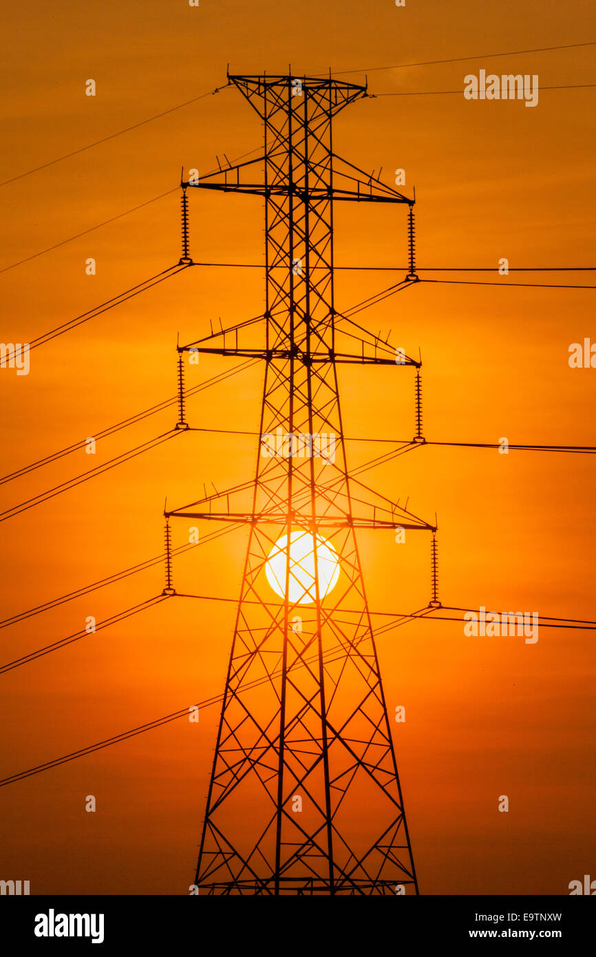 Silhouette of High voltage tower and the sun Stock Photo - Alamy