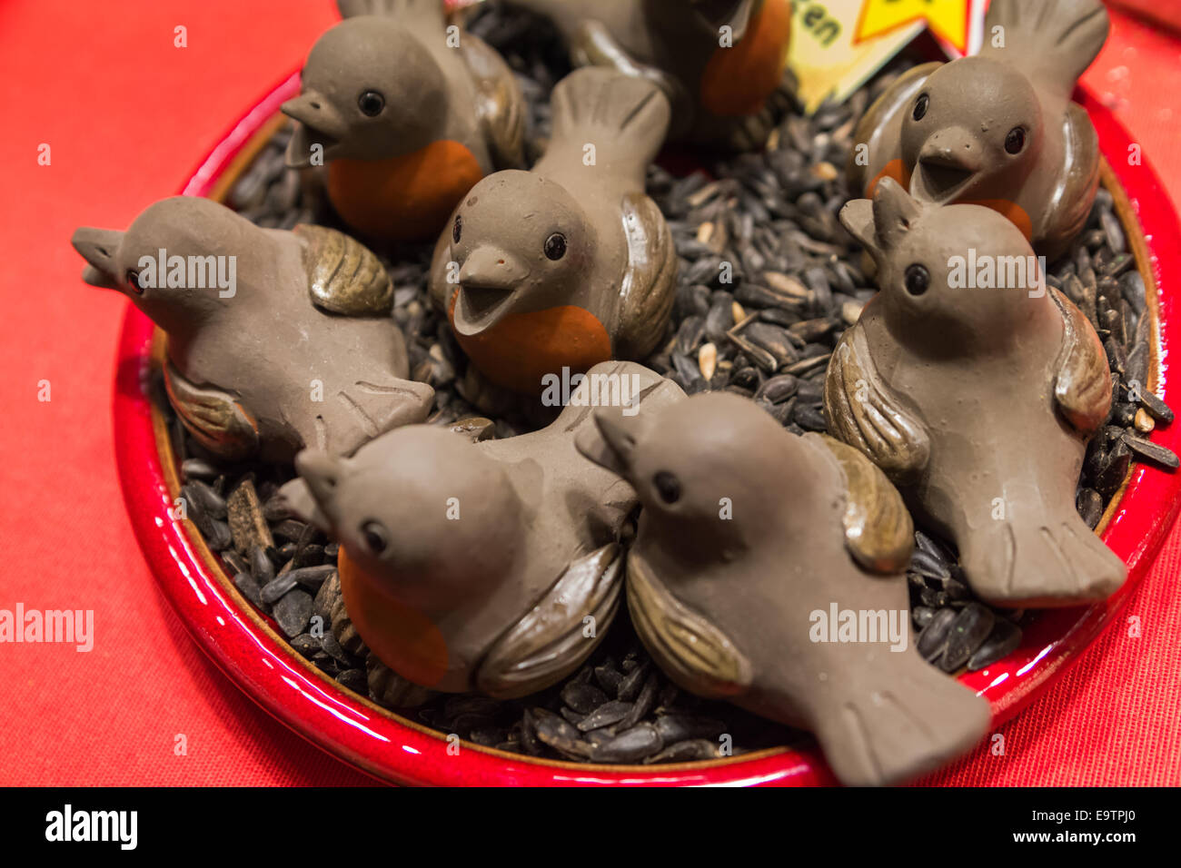 Handmade holiday decorations, birds in a nest on sunflower seeds Stock Photo