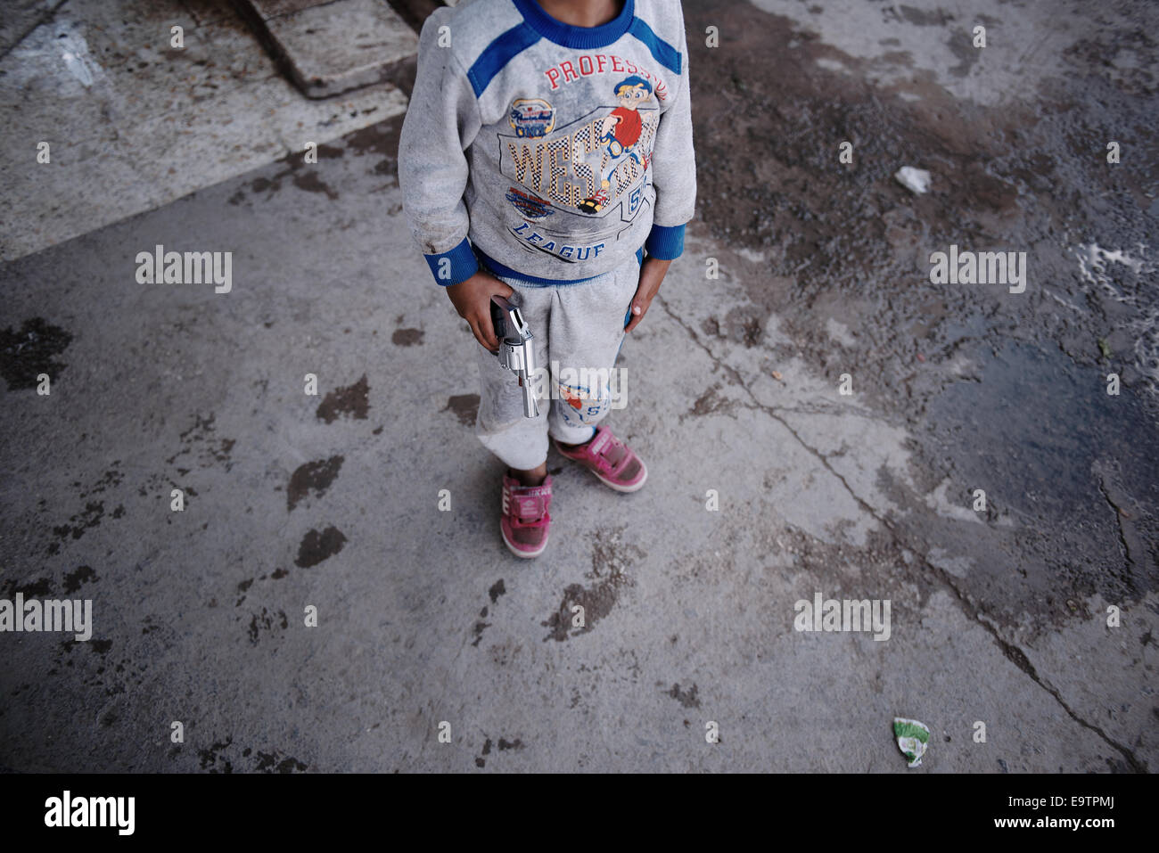 The child of a Kurdish refugee family from Kobane, which lives in an abandoned gas station in the Turkish town of Suruc, Turkey Stock Photo