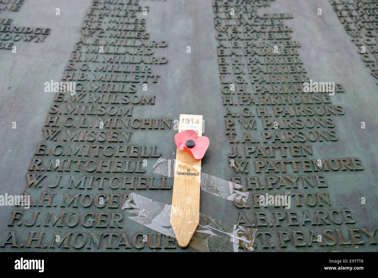 Remembrance poppy placed next to the list of fallen service personnel on the war memorial in Bath,Somerset,England,UK Stock Photo