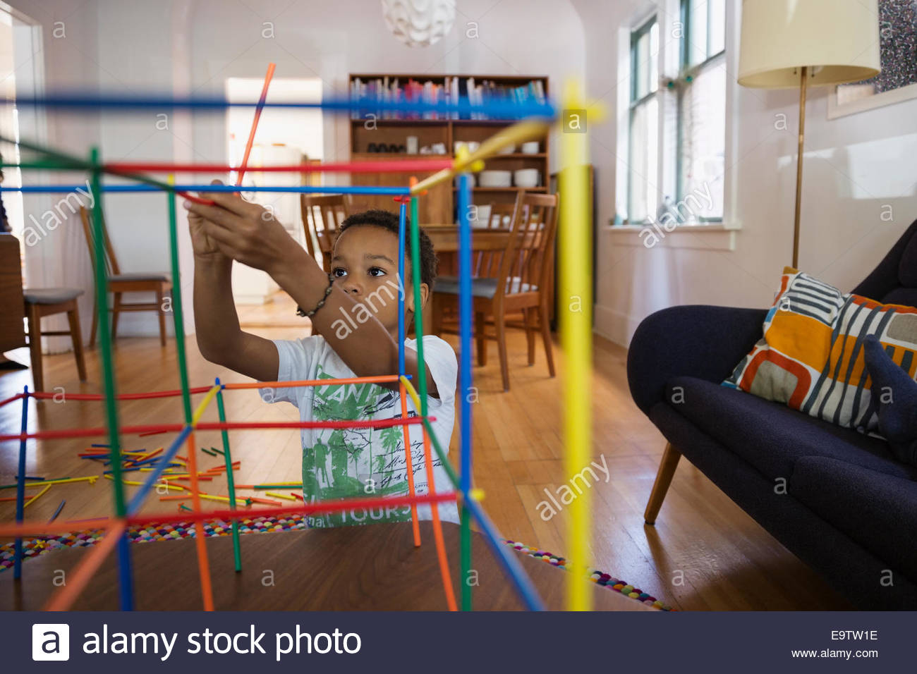 Boy constructing connector toy in living room Stock Photo