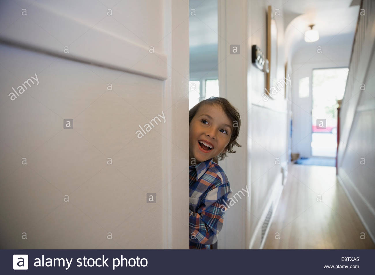 Excited boy in doorway Stock Photo