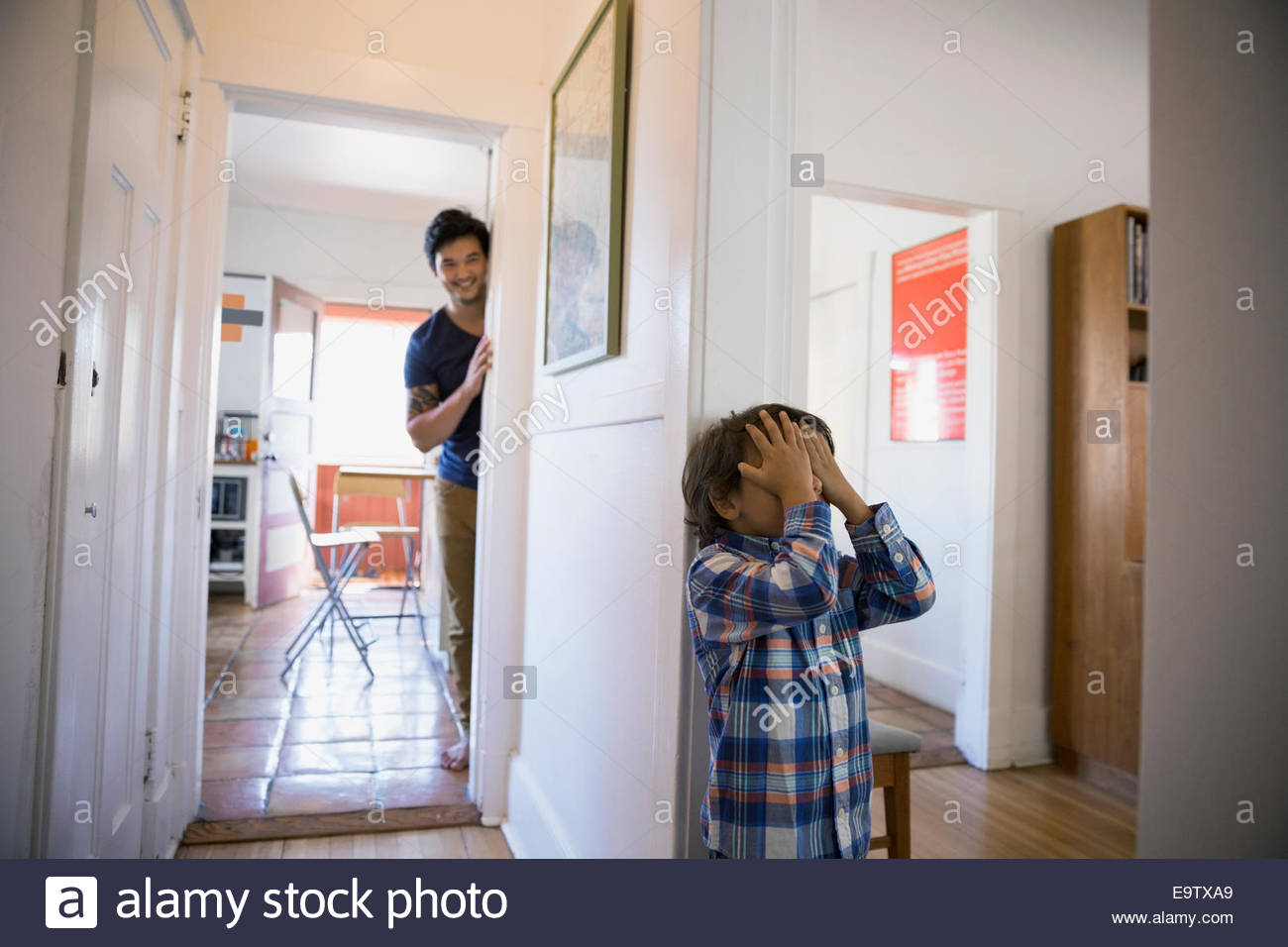 Father and son playing hide-and-seek Stock Photo: 74920897 - Alamy