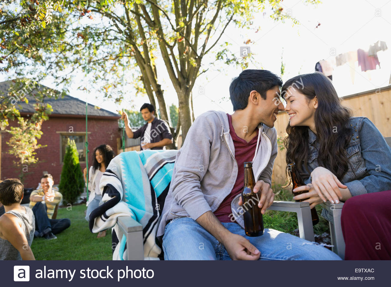 Couple rubbing noses at backyard barbecue Stock Photo