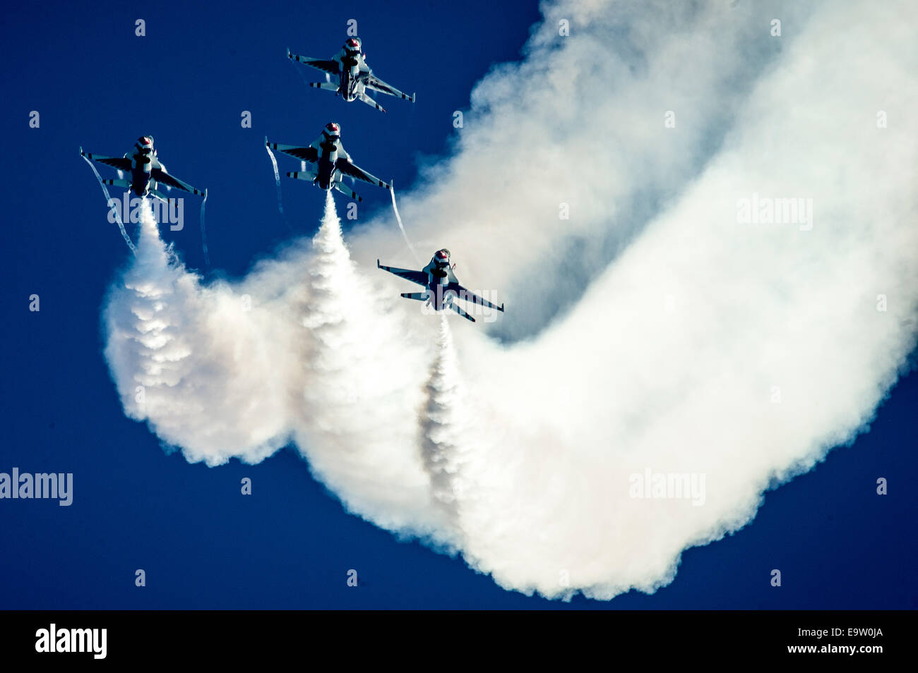 U.S. Air Force pilots with the Thunderbirds perform an arrowhead loop in F-16 Fighting Falcon aircraft during the Wings and Waves Air Show in Daytona Beach, Fla., Oct. 12, 2014. Stock Photo