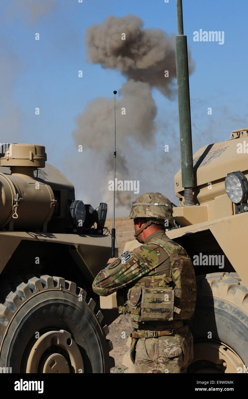 U.S. Army Spc. Anthony Buono, an explosive ordnance disposal technician with the 787th Ordnance Company, 3rd Ordnance Battalion, uses a remote control device to detonate expired and unserviceable explosives Oct. 15, 2014, near Kandahar Airfield, Afghanist Stock Photo