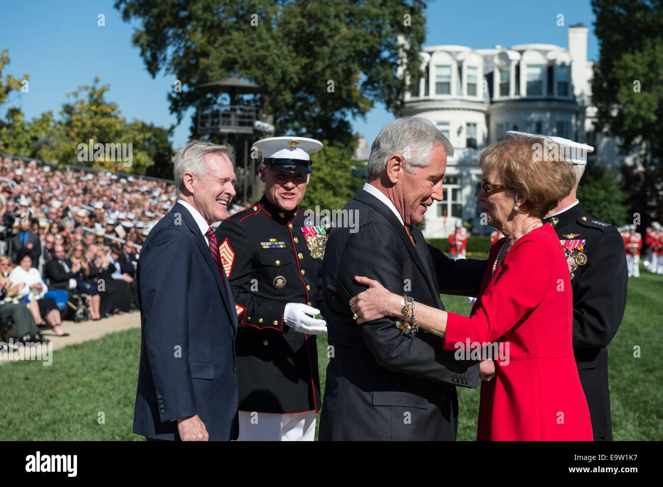 Secretary of Defense Chuck Hagel, left foreground, speaks with Bonnie Amos, the wife of Commandant of the Marine Corps Gen. James F. Amos, during a change of command ceremony Oct. 17, 2014, at Marine Barracks Washington in Washington, D.C. During the even Stock Photo