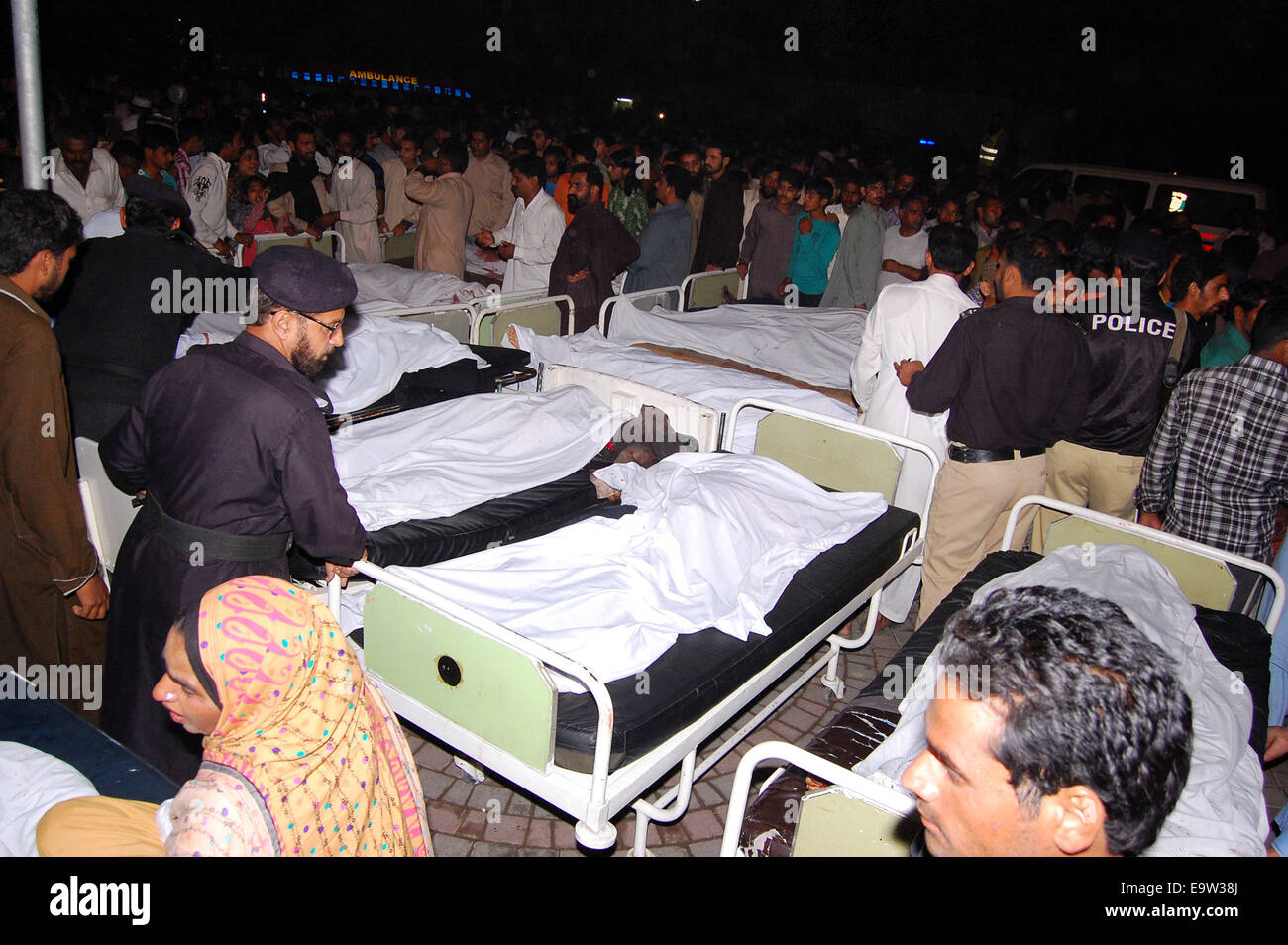 Lahore. 2nd Nov, 2014. Pakistani relatives gather around the bodies of blast victims at a hospital after a suicide bomb attack near Wagah border in eastern Pakistan's Lahore on Nov. 2, 2014. Death toll rose to 54 and over 100 others were injured in the Sunday evening's suicide blast that took place near Wagah border crossing in Pakistan's eastern city of Lahore, hospital sources said. Credit:  Xinhua/Alamy Live News Stock Photo