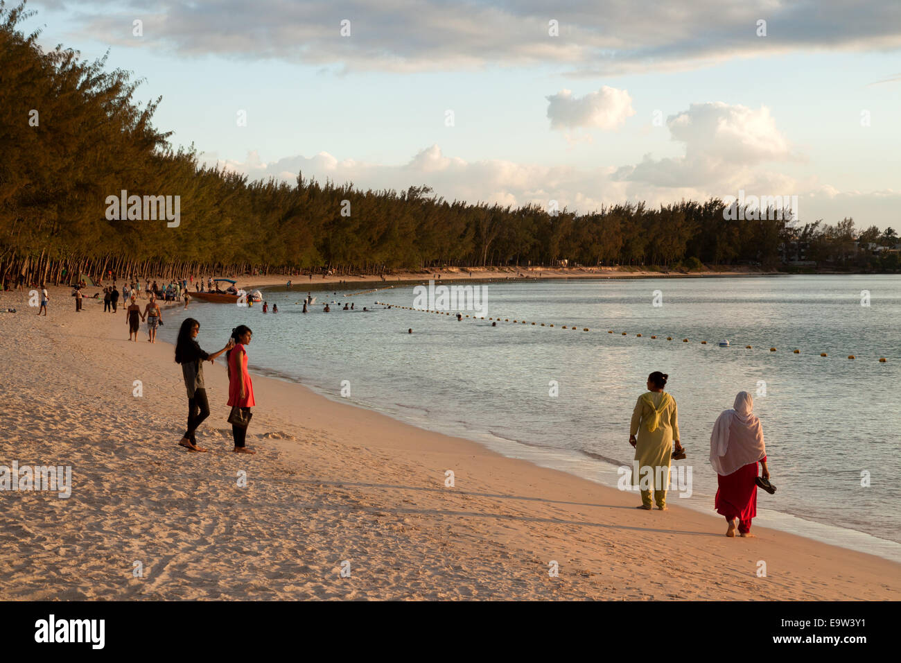 Local mauritian  people on Mont Choisy beach at sunset, north coast, Mauritius Stock Photo
