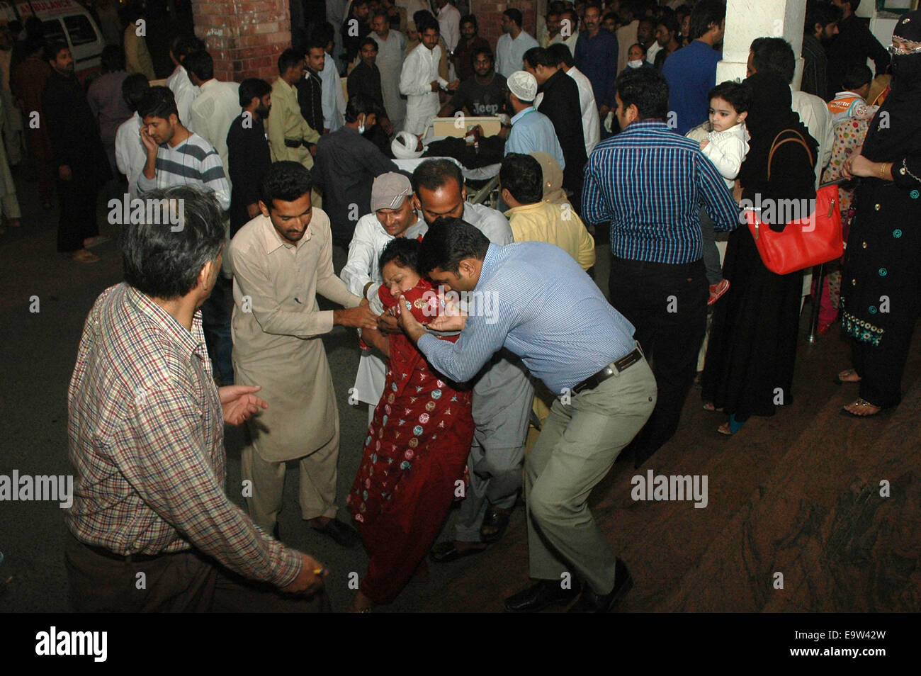 Lahore. 2nd Nov, 2014. People transfer an injured woman to a hospital in eastern Pakistan's Lahore on Nov. 2, 2014. Death toll rose to 54 and over 100 others were injured in the Sunday evening's suicide blast that took place near Wagah border crossing in Pakistan's eastern city of Lahore, hospital sources said. Credit:  Sajjad/Xinhua/Alamy Live News Stock Photo