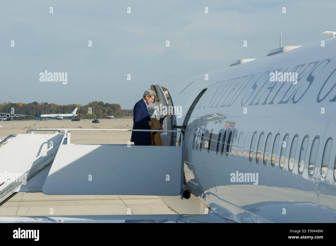 U.S. Secretary of State John Kerry boards his plane at Andrews Air Force Base in suburban Washington as he heads to Ottawa, Canada, on Oct. 28, 2014. Secretary Kerry is traveling to Canada to extend his condolences in the aftermath of last week's shooting Stock Photo