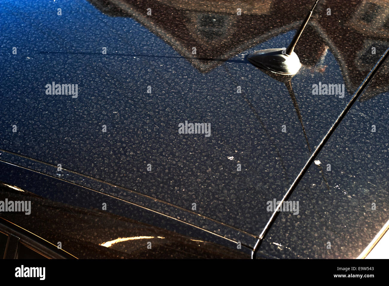 top of a dirty black car roof covered in fine silt marks Stock Photo