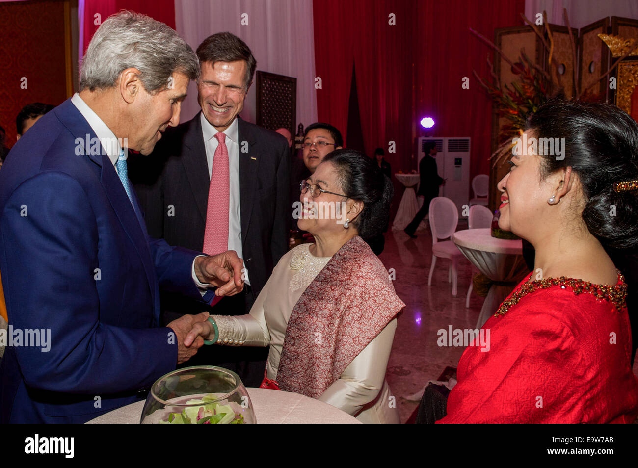U.S. Secretary of State John Kerry chats with former President of Indonesia Megawati Sukarnoputri and her daughter, Puan Maharani, at a reception after representing President Obama at inauguration ceremonies for Indonesian President Joko Widodo in Jakarta Stock Photo