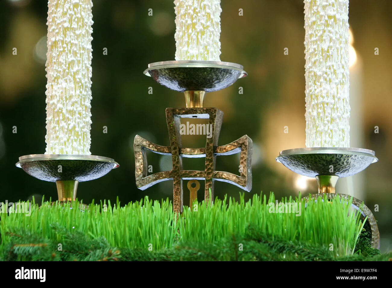 A candlestick with cross and tree candles on church altar Stock Photo