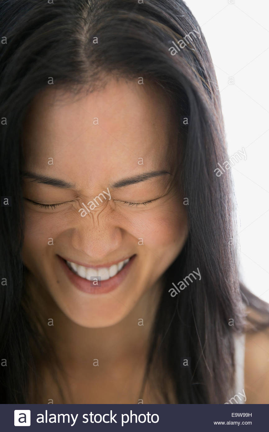 Close up of laughing woman with eyes closed Stock Photo