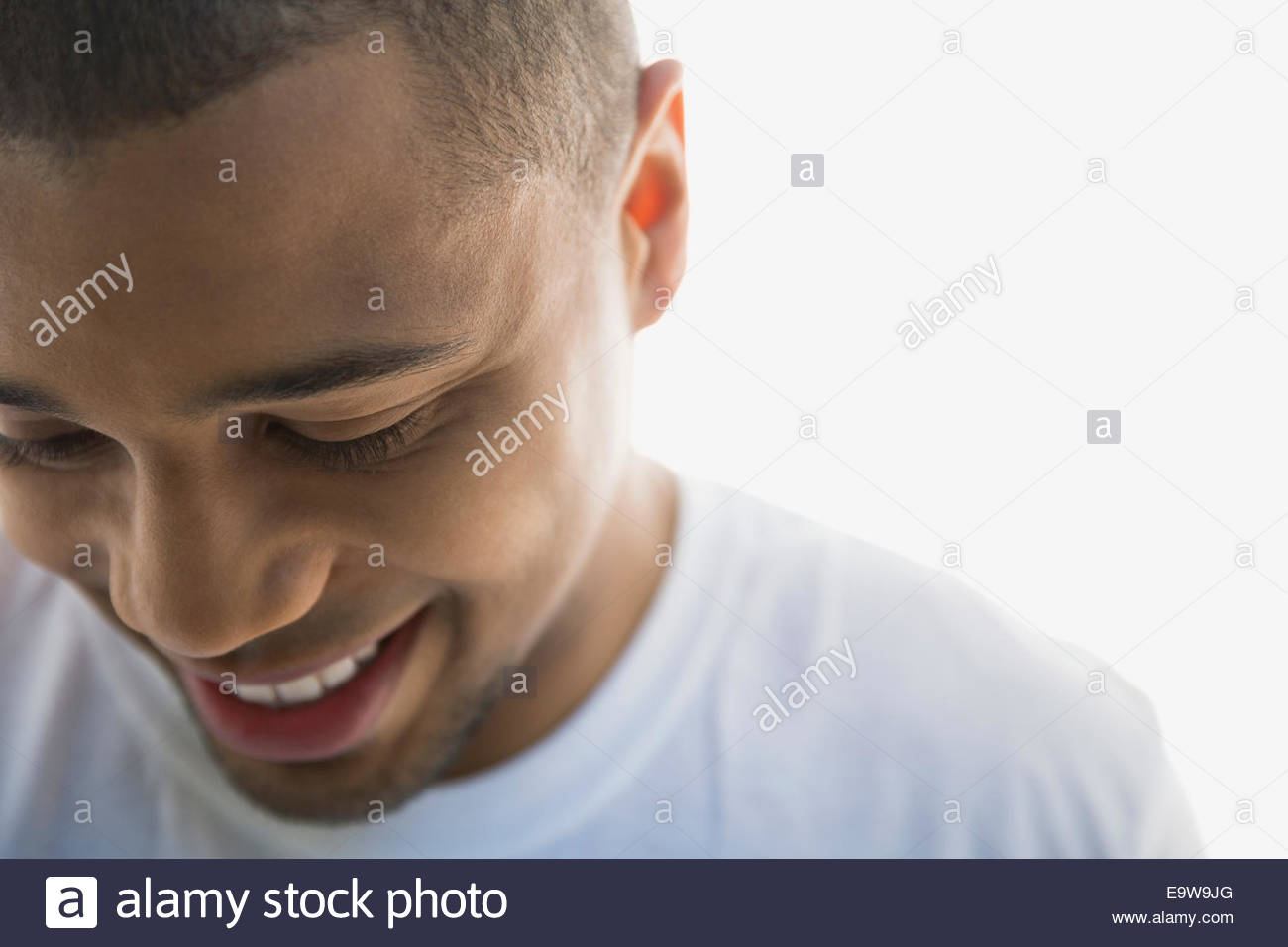 Close up portrait of smiling man looking down Stock Photo