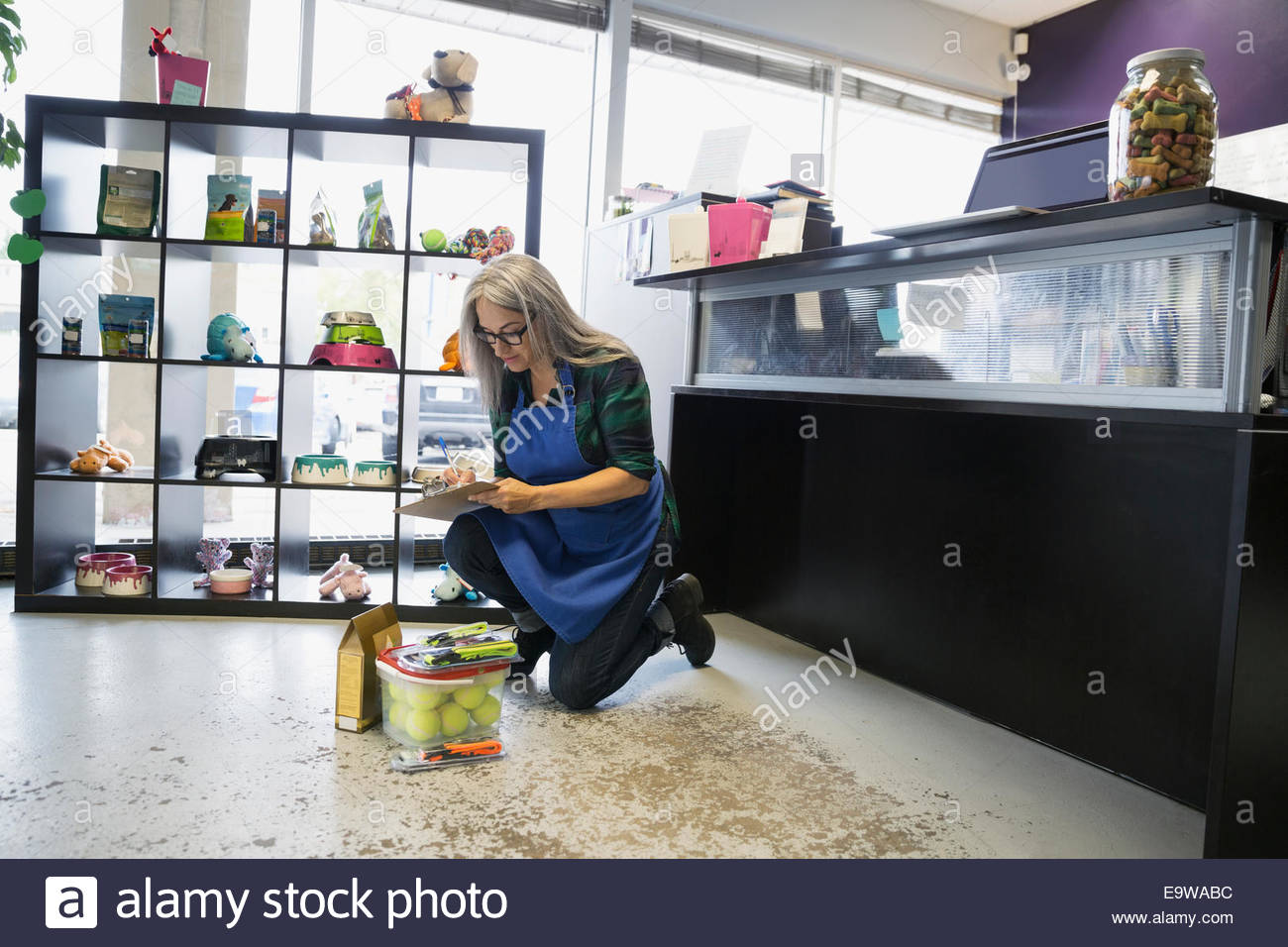 Dog daycare owner checking inventory Stock Photo