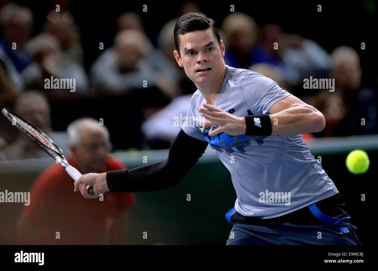 Paris, France. 2nd Nov, 2014. Milos Raonic of Canada hits a return during  the men's singles final match against Novak Djokovic of Serbia at the ATP  World Tour Masters 1000 indoor tennis