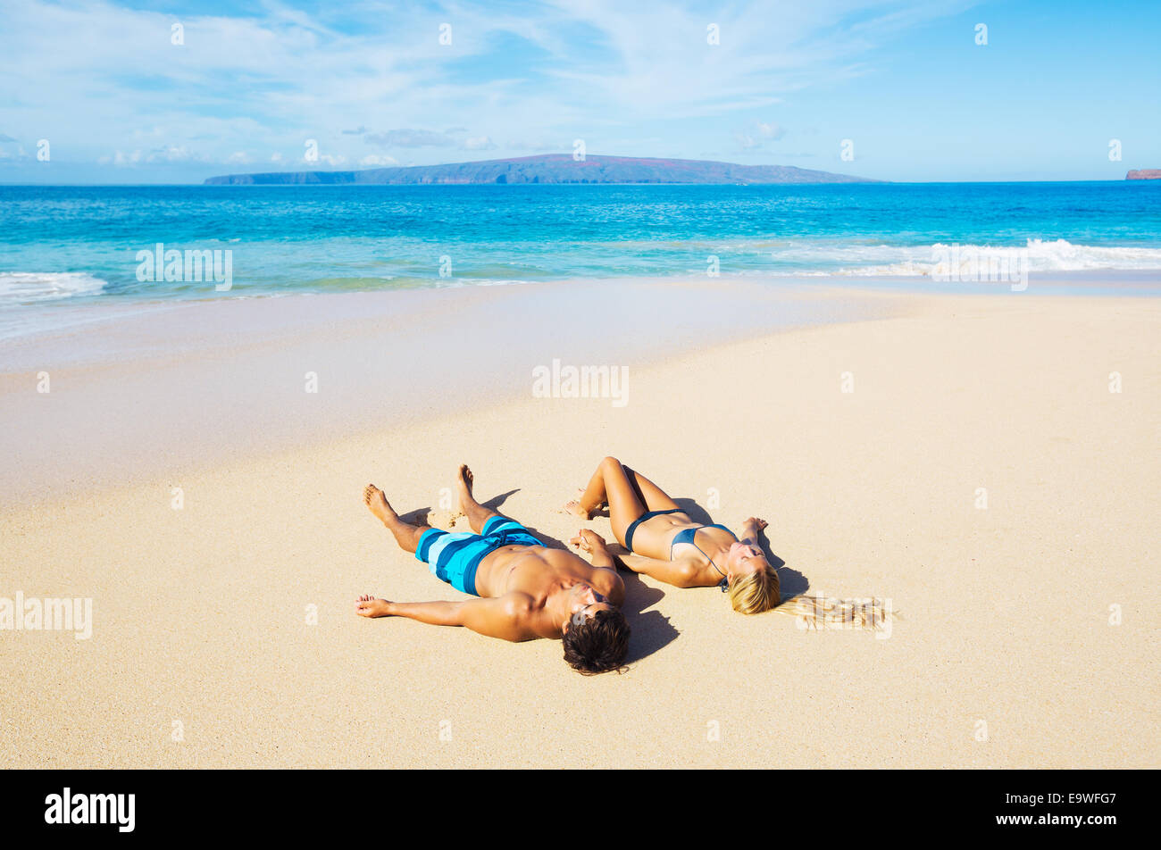 Attractive Couple Relaxing on Sandy Beach, Tropical Vacation Stock Photo