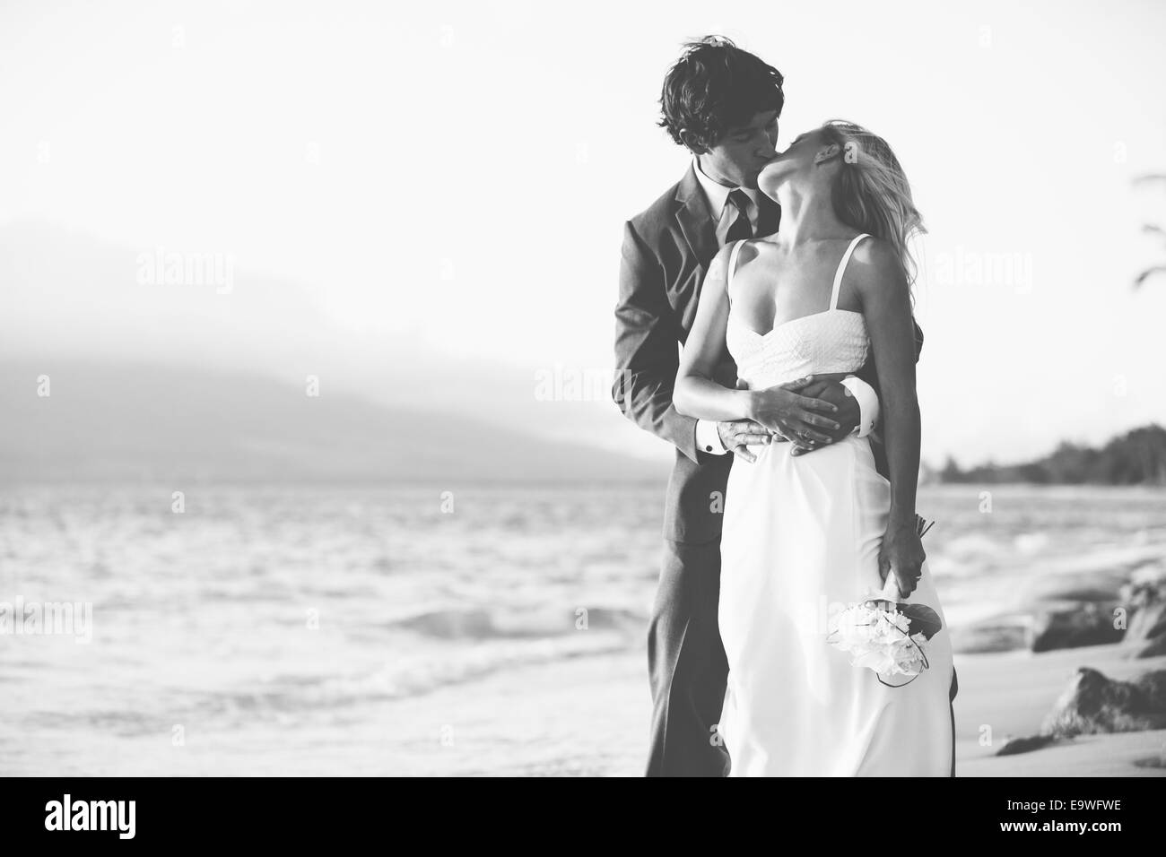 Beautiful Wedding Couple, Bride and Groom Kissing on the Beach at ...