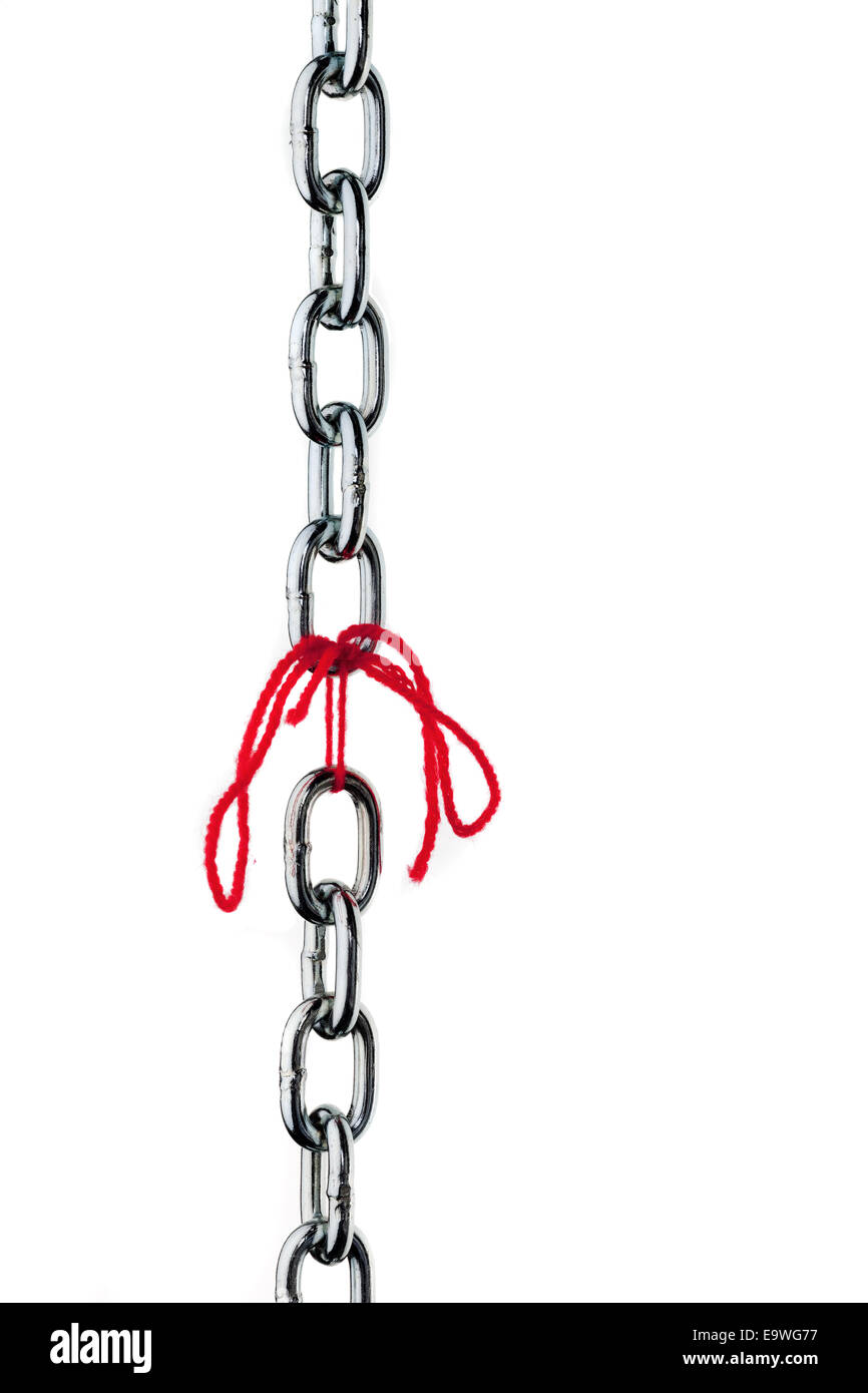 Defective steel chain is held together by a thread Stock Photo