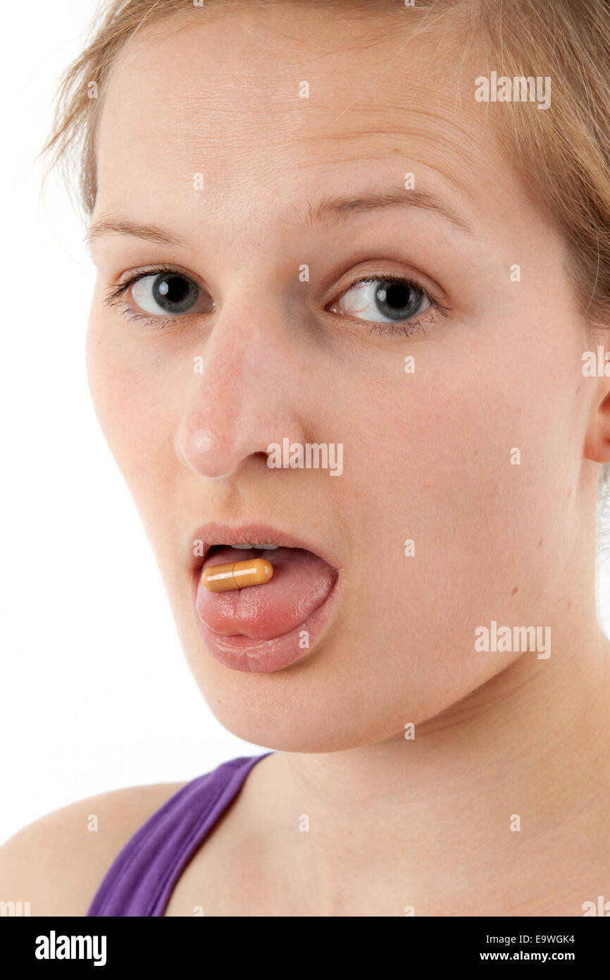 Young woman swallows capsules Stock Photo Alamy