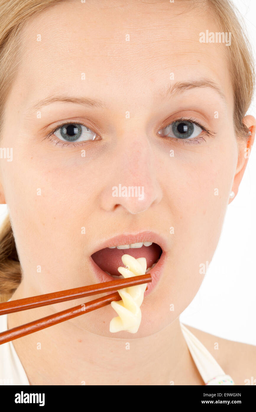 Young woman takes an extremly small food portion Stock Photo